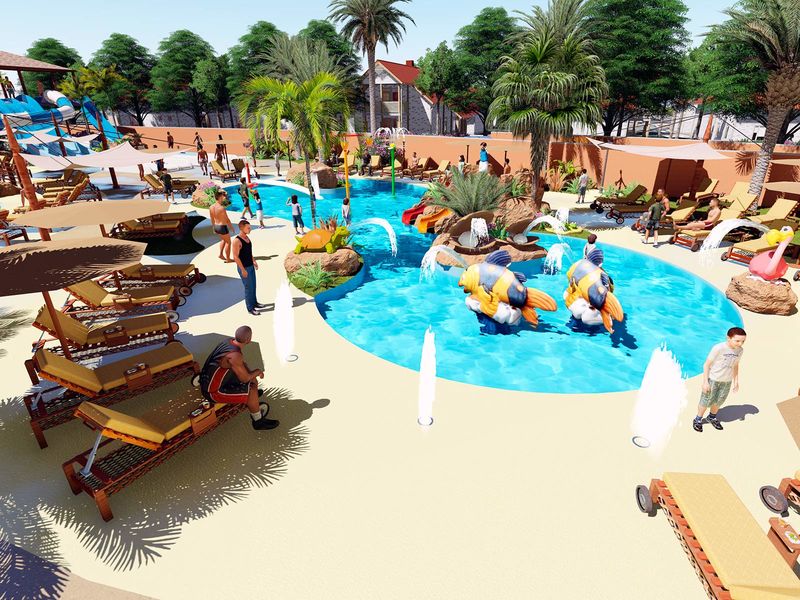 People enjoying a swimming pool and lounging under umbrellas surrounded by palm trees and vibrant greenery at Le Saint Louis